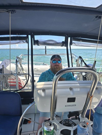 Lance sailing at the helm